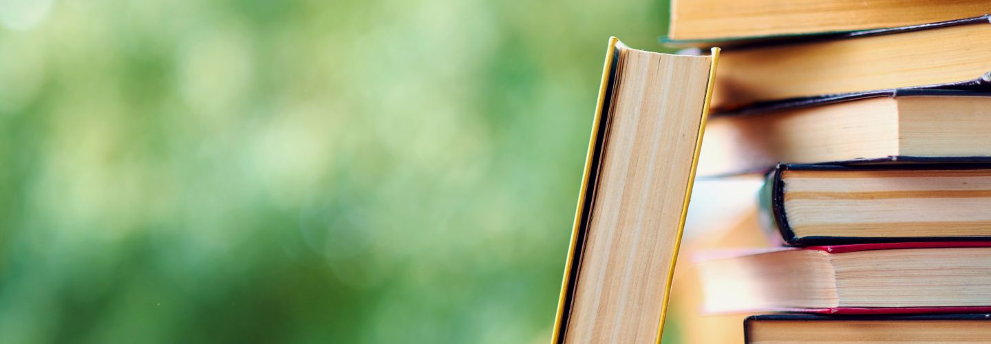 Stack of books with green background